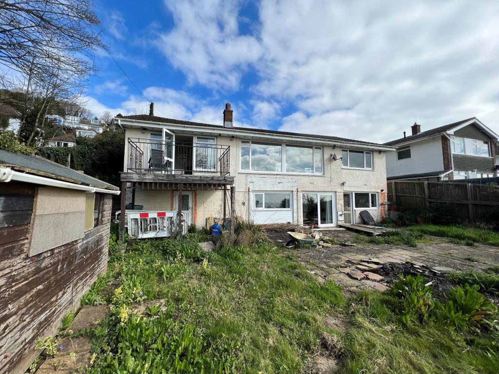 Lot: 138 - HOUSE WITH SEA VIEWS WITH CONSENT FOR DEMOLITION AND CONSTRUCTION OF SIX TWO-BEDROOM APARTMENTS - Rear photo of bungalow with sea views in Ventnor Isle of Wight